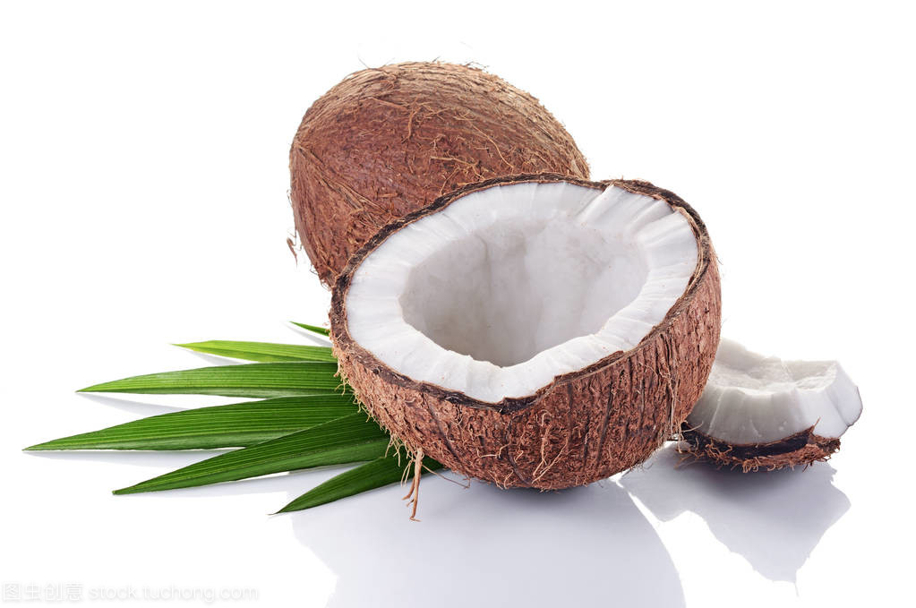 健康的食物。新鮮的椰子與綠色的棕櫚葉